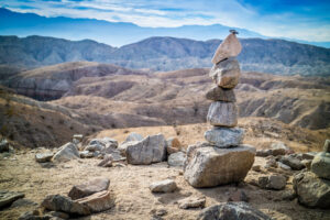A human made pile of rocks in Painted Canyon Ladder Hike Trail at Palm Springs with mountain views