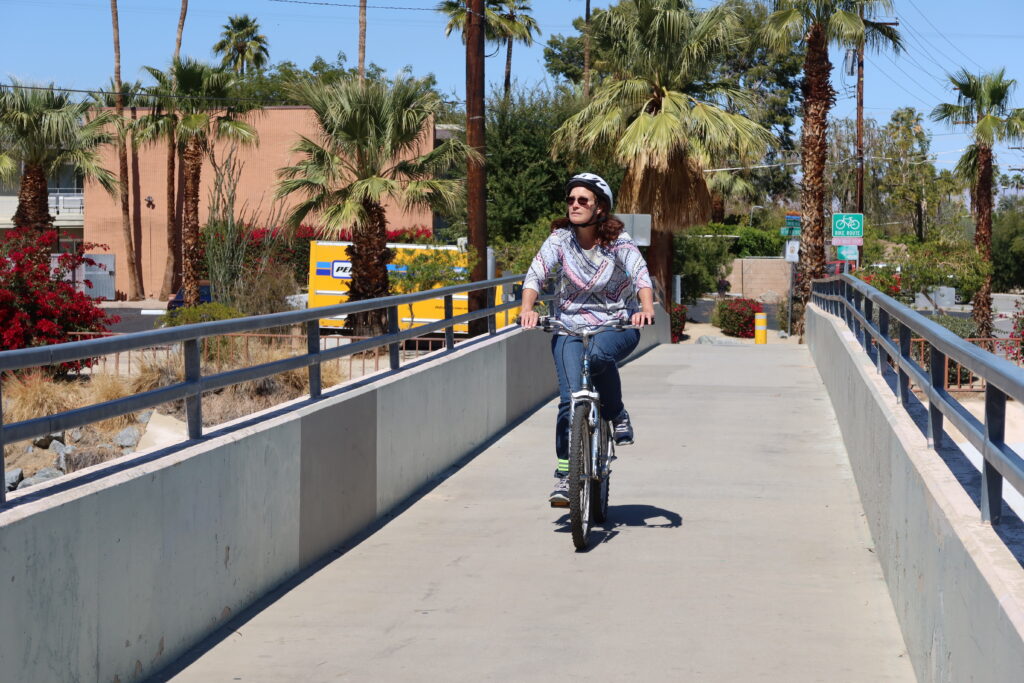 Woman Riding a Bicycle on a Bridge in Palm Springs, California,