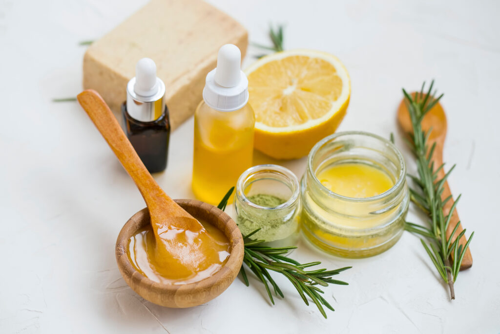 Natural skincare ingredients with manuka honey, lemon, essential oil, clay, balm, rosemary herbs and natural soap, healthy wellness and spa products , natural and homemade ingredients