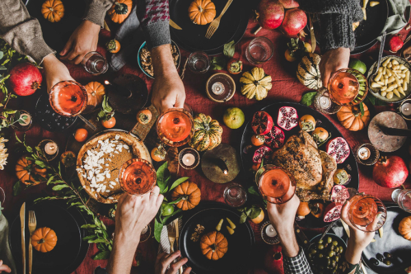 thanksgiving table with pumpkins and food and drinks