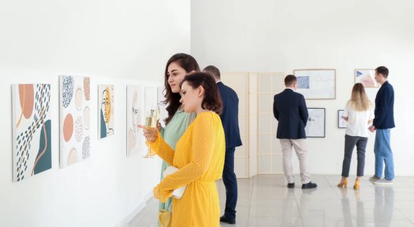 two ladies look at art in gallery